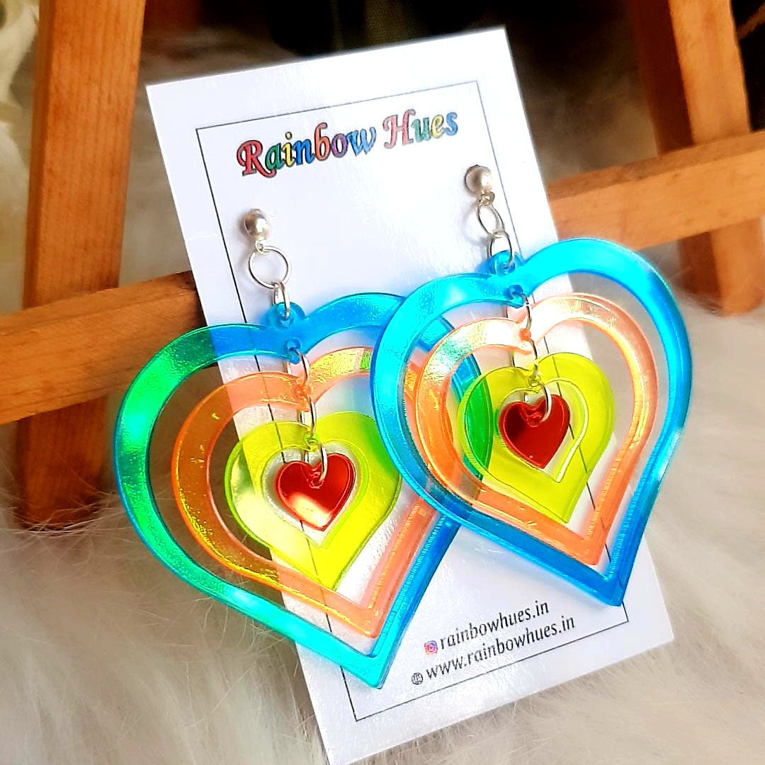 Sparkle with Jazzy Holo Heart Earrings! These dazzling danglers feature a vibrant holographic heart within a heart, sure to add an exciting splash of color to your look. Show your style with this eye-catching jewelry and stand out from the crowd.