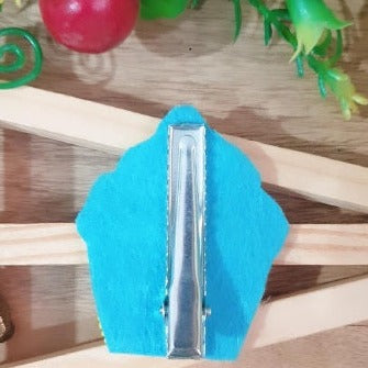 This decorative Handmade Blue & Red Beaded Cupcake Hairclip is handmade with blue and red beads, perfect for adding a statement-making accessory to your hairstyle. With intricate details and a unique design, it will bring a festive touch to any outfit.