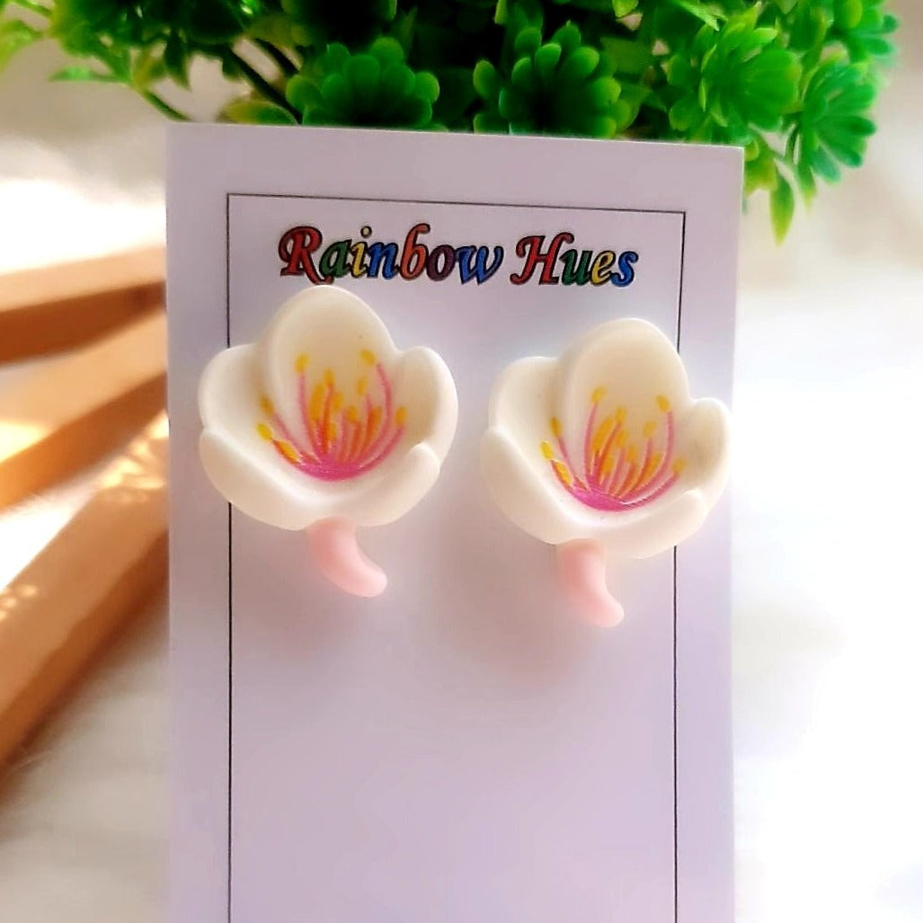 Add an elegant touch to any outfit with our White Lily Studs. These timeless flower-shaped studs sparkle with their delicate, clear crystals, making them a must-have for any special occasion. These beautiful studs are a perfect way to show off your sophisticated style.