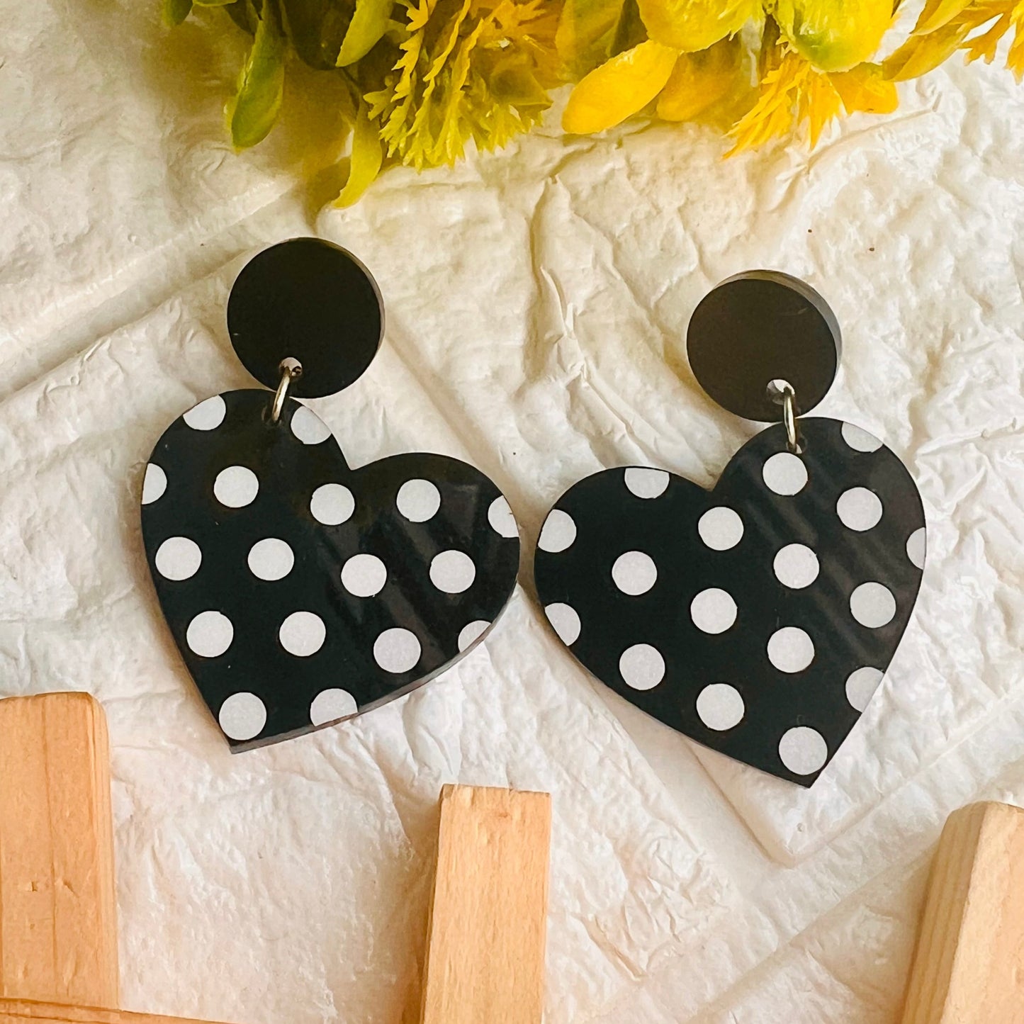 Beautifully crafted, the Polka Dot Heart Earrings will add a timeless accent to your wardrobe. These classic earrings feature white and black polka dot hearts with small cubic zirconia stones in the middle for a unique, sparkly look.