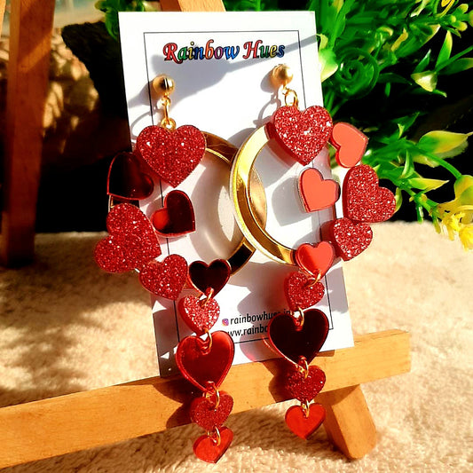 This Valentine's show your love with these gorgeous Queen of Hearts Earrings! Crafted with glitter red and mirror red hearts draped on a golden wreath, these earrings will make any heart melt! Enchanting and unique, you'll be sure to make a statement with these beautiful and timeless earrings.