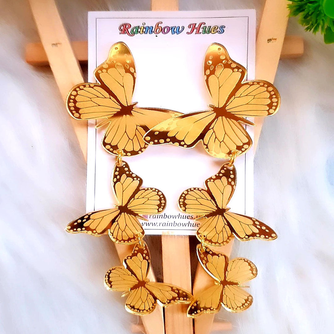 These golden butterfly earrings are an enchanting pair to add a touch of glamour to any occasion. Crafted from a vibrant and glossy gold, these earrings feature a butterfly trio design to make a stunning statement. Let this eye-catching piece of jewelry add a show-stopping sparkle to any look.