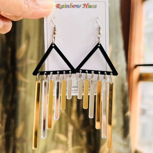 Beautiful and unique black triangles with glossy mirror shine silver and golden hangings that shine and flutter when worn! A stunning piece of jewelry 