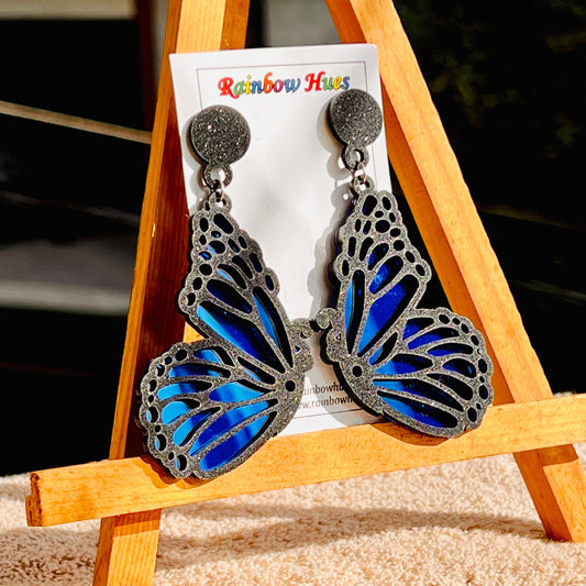 These Night Sky Butterfly Earrings will make you want to spread your wings and fly. Created with glittery night sky accents, these earrings bring a touch of charm and whimsy to any ensemble. Let your inner butterfly free with these gorgeous earrings!