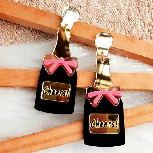These Champagne Pop Earrings are the perfect finishing touch for any evening look. Crafted from glossy gold and black with a feminine pink bow, these earrings will bring a bit of sparkle and shine wherever you go.