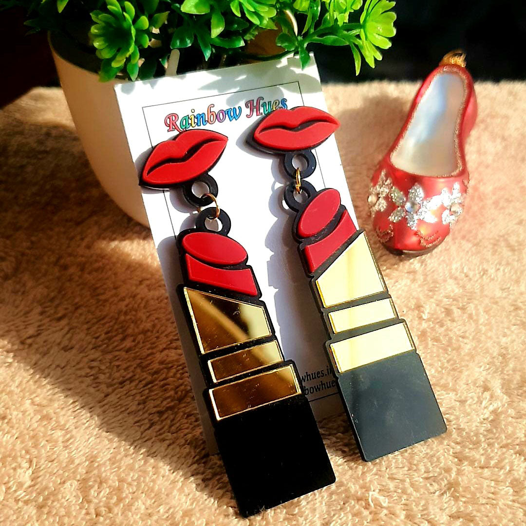 Make a bold statement in our stunning Lipstick Earrings! These lightweight earrings complement any outfit and any occasion. Crafted with detailed precision and bright colors, these earrings will elevate your look in no time. Get ready to make a statement!