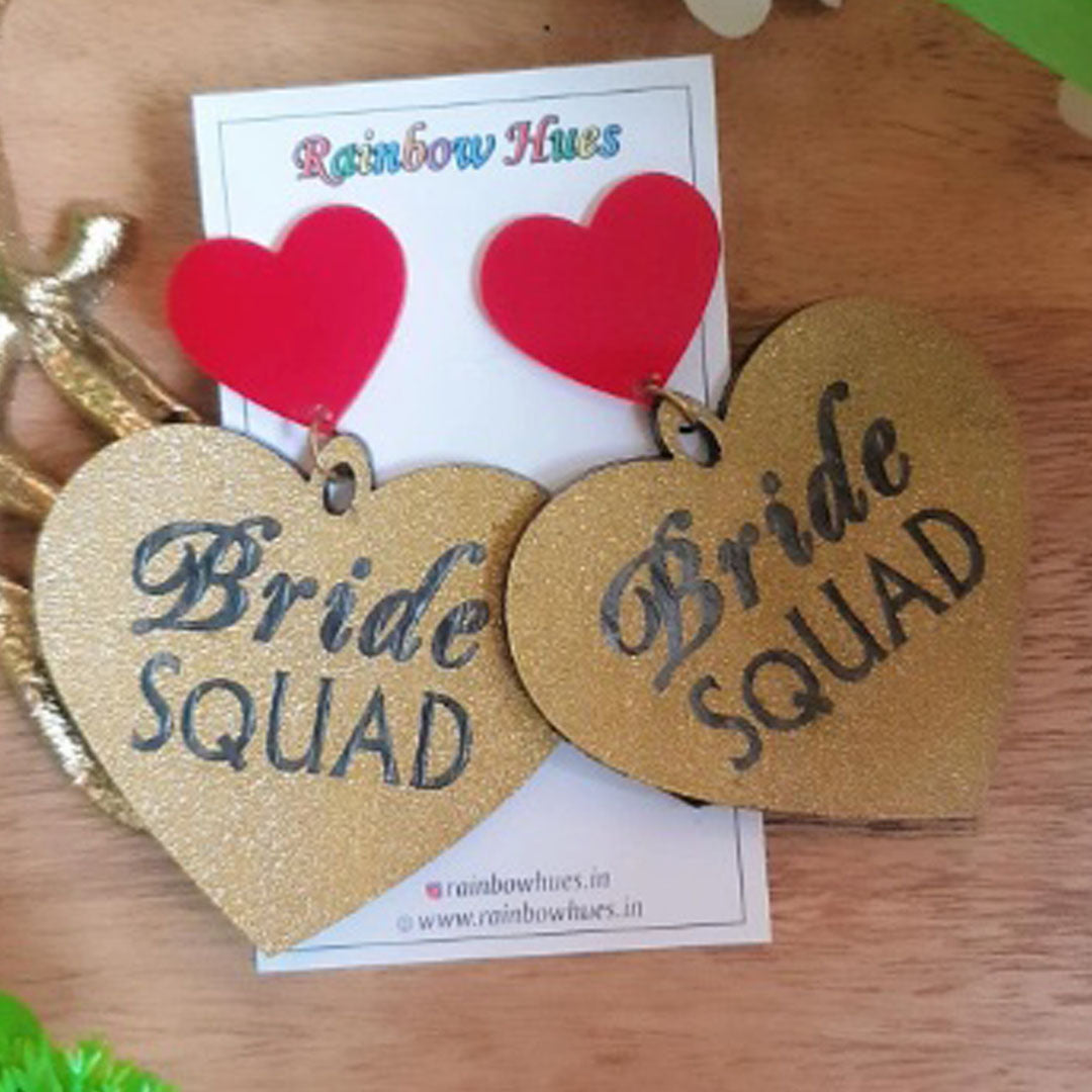 A beautiful pair of glitter golden Bride Earrings with a red heart for the beautiful bride to be! Perfect for some unique photos at your upcoming bachelorette bash!