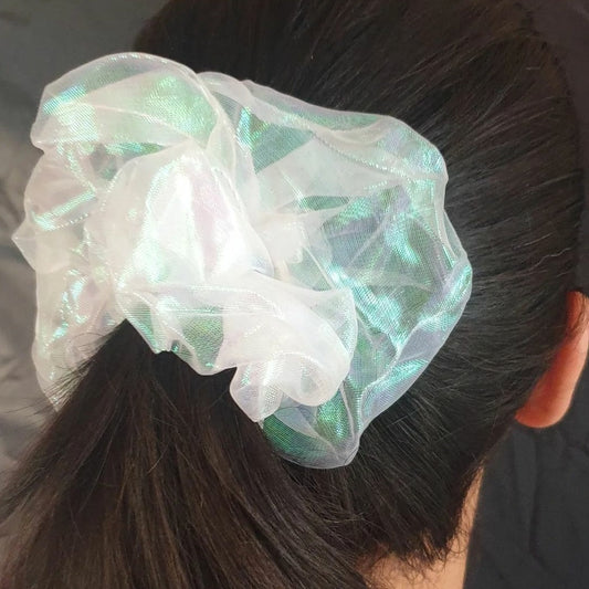 This Holographic Scrunchie is a must-have accessory for any modern wardrobe. Its shimmery holographic fabric adds a sparkle that will definitely make you stand out. Tie it around your hair, wrist or bag for a dazzling touch of glamour.