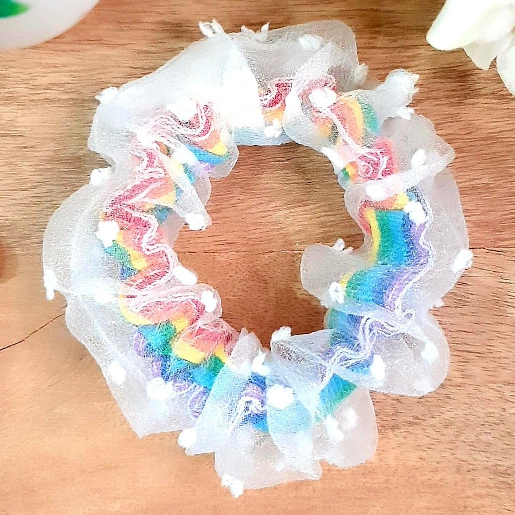 This Rainbow Scrunchie is a beautiful accessory. It features double layers for durability and rainbow colors for a dazzling look. Make a statement with this fashionable and long-lasting scrunchie.