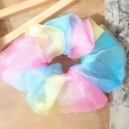 Add a touch of colour to your hair with our Rainbow Pastel Organza Scrunchie. Featuring pretty pastel colours, this fashionable scrunchie is made from soft and lightweight organza fabric for an effortless and elegant look. Perfect for everyday wear or special occasions.