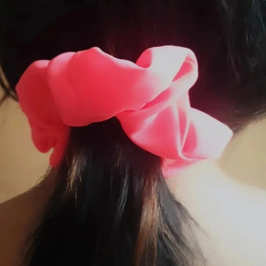 This stunning Neon Hot Pink Scrunchie is the perfect way to add a bold touch to your ensemble. The bright hot pink color stands out for an eye-catching look that won't go unnoticed. With its strong fabric, it ensures your hair stays in place all day and adds a stylish flair to your look.