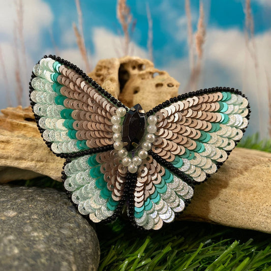 This handmade blue butterfly sequin hairclip is the perfect accessory for any look. Crafted with a shimmering sea blue sequin, this handmade hairclip is sure to add a stylish, light-catching touch to your hair. Get ready to make a statement with this one-of-a-kind accessory.
