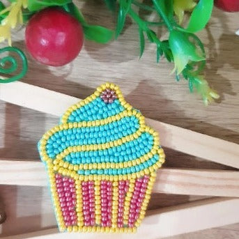 This decorative Handmade Blue & Red Beaded Cupcake Hairclip is handmade with blue and red beads, perfect for adding a statement-making accessory to your hairstyle. With intricate details and a unique design, it will bring a festive touch to any outfit.