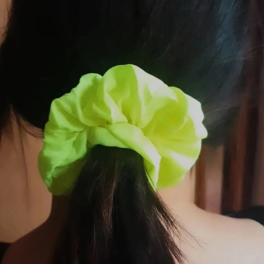 Make a bold statement with this fluorescent neon scrunchie. Combining a sleek design with eye-catching color, this scrunchie will provide a pop of personality to any outfit. For a fashionable look that stands out, the neon fluorescent scrunchie is an essential accessory.