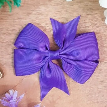 This high-quality Purple Bow Clip will add a touch of sophistication to any outfit. The bow is made of durable fabric and includes a secure alligator clip for easy fastening. Show off your style in a subtle way with this beautiful purple bow.