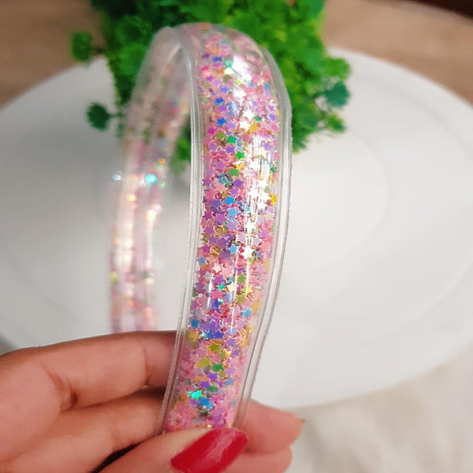 The Star Sequin Shaker Hairband is the perfect way to make a statement. Filled with colourful star sequins, this hair accessory will shimmer and shine with every movement of your head. Accessorize your look with a unique and eye-catching hairdo. #StarSequinShakerHairband