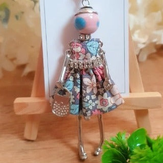 This unique Dancing Summer Doll Necklace is sure to make a statement! Handcrafted from beautiful materials, its lifelike design features a doll whose hands, legs, and body move, perfect for expressing your style in the most stylish way. Show off your summer vibes with this eye-catching accessory!