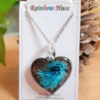This Blue Floral Heart Glass Necklace will add an elegant touch to any ensemble. Handcrafted with loving care, each piece features a stunning blue flower and unique glass heart design. Perfect for special occasions or everyday wear. Get one today for a timeless accessory that you'll treasure for years to come.