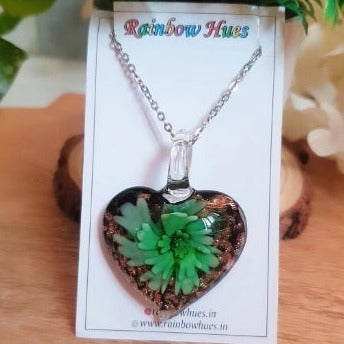 This beautiful Green Floral Heart Glass Necklace will adorn you with elegance and style! The unique glass heart pendant features a stunning green floral detailing. Each handmade necklace is unique - your piece will be one-of-a-kind. Let this eye-catching accessory elevate your look with a touch of everyday luxury!