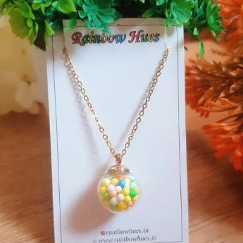 This charming Rainbow Confetti Globe Necklace is a must-have for any fun-loving fashionista! Adorned with bright coloured confetti balls in a intricate glass globe, this unique necklace is sure to be the envy of all your friends. Show off your whimsical style with this beautiful, dainty necklace!