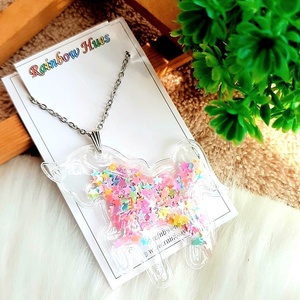 Be the life of the party with this super cute Unicorn Shaker Necklace! Featuring a vibrant rainbow of star Confetti, this statement piece offers a fun and festive way to accessorize any outfit. Be the envy of all your friends with this unique and stylish necklace!