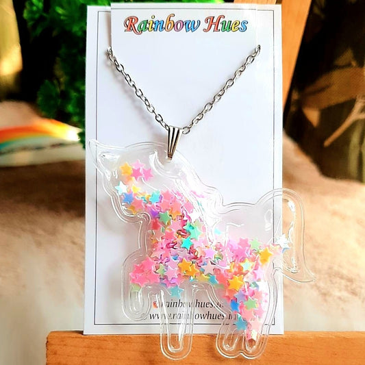 Be the life of the party with this super cute Unicorn Shaker Necklace! Featuring a vibrant rainbow of star Confetti, this statement piece offers a fun and festive way to accessorize any outfit. Be the envy of all your friends with this unique and stylish necklace!