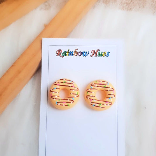 Treat yourself to a deliciously sweet style with these Mango Doughnut Stud Earrings! The perfect combination of delightful and fashionable, these earrings will add a fun, unique flare to any wardrobe. Get them while they're hot!