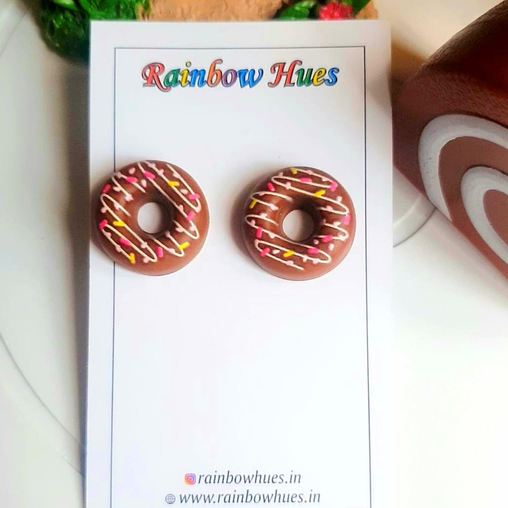 Treat your ears to something sweet! These eye-catching Coffee Doughnut Stud Earrings are sure to satisfy your cravings for stylish jewelry. They make an ideal accessory for any outfit, and you'll always be in the mood for donuts with these delightful earrings!