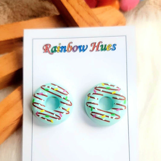 Add a burst of flavor to your jewelry collection with these Blueberry Doughnut Stud Earrings! Featuring two colorful doughnuts made of lightweight material, these studs are the perfect accessory for any style. Indulge in the tasty trend and show off your sweet side!