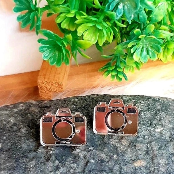 Capture the perfect accessory with these chic Camera Earrings! Crafted from mirror silver, these earrings are sure to elevate your look with their stylish charm. Show off your love for photography in a beautiful and delicate way that will turn heads.