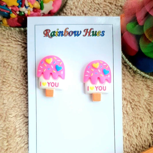 Show your unique style with these sweet 'I Love U' Popsicle studs! Show your special someone how you feel and express your love with these beautiful earrings. ♡ These earrings make an unforgettable, meaningful gift. Their pink and blue hues will evoke a feeling of optimism and will be a reminder that love is always in the air.