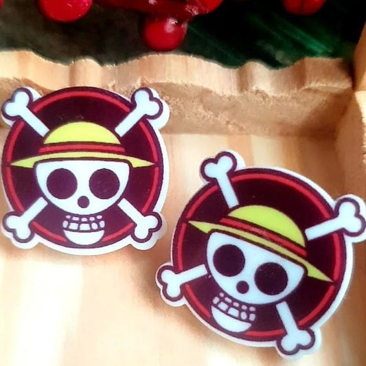 Style your ears with these unique One Piece stud earrings! Inspired by the iconic anime, each earring features a straw hat and skull pirate design sure to make a statement. Make your look standout and show off your love for the anime series!