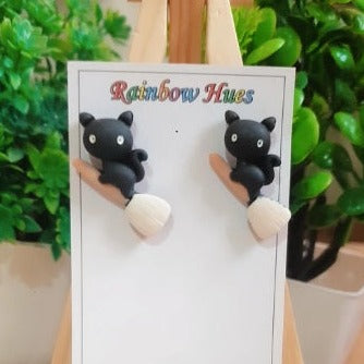 Show off your unique flair with these stylish Kitty N Broom Stud Earrings! Perfect for any occasion, these little charmers are sure to bring a smile to anyone's face with their fun and spirited design. Make a statement with these charming earrings and show your style!