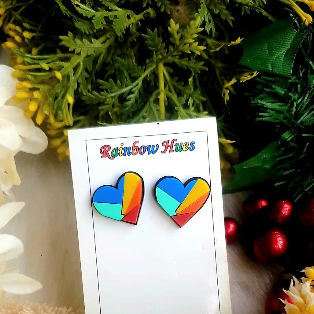 Pride Earrings. Delight in a colorful and vibrant expression of love with our Rainbow Heart Studs. Crafted to last with a secure post back fastening, these earrings are a beautiful accessory to brighten your Pride day. Show your true colors with these striking studs!